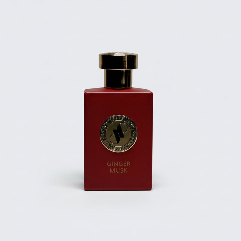 Red perfume bottle with gold cap and label on a white background